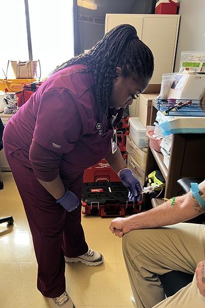 Bridge Team member providing medical care at Integral Care facility